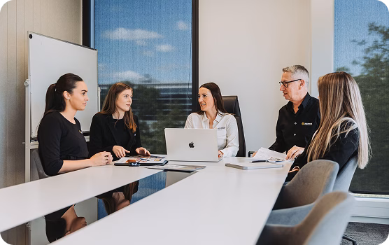 Team meeting around a table in a bright office